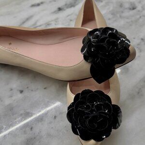 Kate Spade Beige flats with black leather flower on toe of shoe